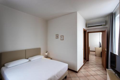 a bedroom with a bed and a flat screen tv at Residenza Cavour in Parma