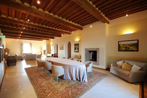 a large living room with a table and a couch at Relais Villa Grazianella | UNA Esperienze in Acquaviva