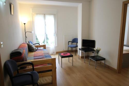 a living room with a couch and a tv at APARTAMENTO LABEGAIN 2 in Sestao