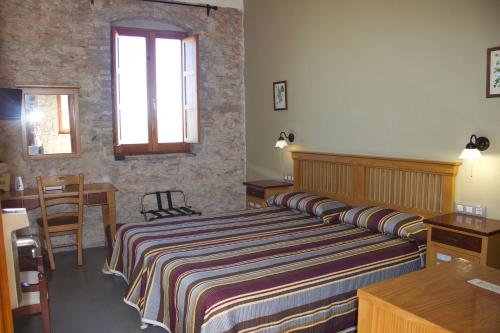 Cama o camas de una habitación en Hotel Muralleta
