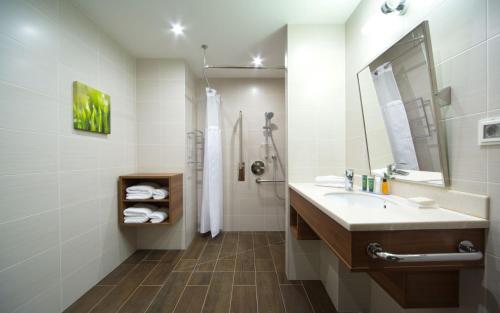a bathroom with a sink, toilet and shower at Hilton Garden Inn Moscow Krasnoselskaya in Moscow