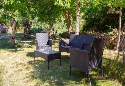 a group of chairs and a table in the grass at Hotel Rural Calatañazor in Calatañazor
