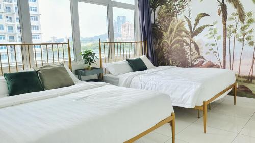 two beds in a room with a large window at No.10 The Vintage @ Diffrent Home Feeling in Puchong