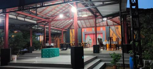 a large building with tables and chairs in it at Penginapan Pendopo Kasih in Pugeran