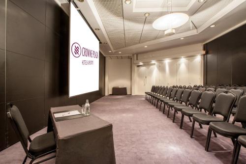 a conference room with chairs and a projection screen at Crowne Plaza Helsinki - Hesperia by IHG in Helsinki