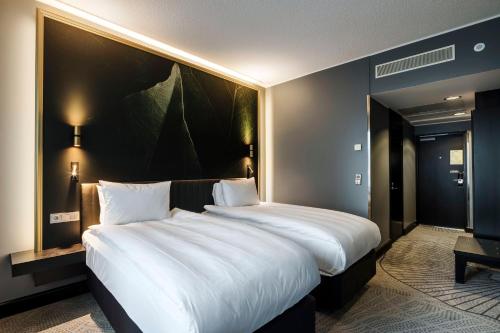 a large bed in a hotel room with a large white bed at Crowne Plaza Helsinki - Hesperia by IHG in Helsinki