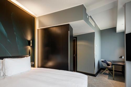 a hotel room with a bed and a desk at Crowne Plaza Helsinki - Hesperia by IHG in Helsinki