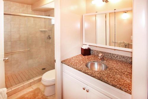 a bathroom with a sink and a toilet and a shower at Kealia Resort 203 in Kihei