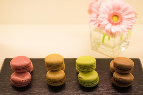 a group of different colored donuts on a table at La Reggia Sporting Center Hotel in Cascia