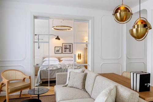 a living room with a couch and a bedroom at Heritage Hotel FERMAI MGallery Split in Split