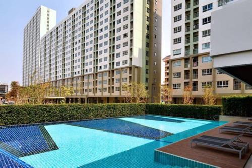 a large swimming pool in front of a building at Nice Condo near Ramkhamhaeng 60, Lam Sali MRT in Bangkok