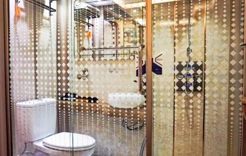 a bathroom with a toilet and a glass shower at TABHotel Capsule Bandung in Bandung