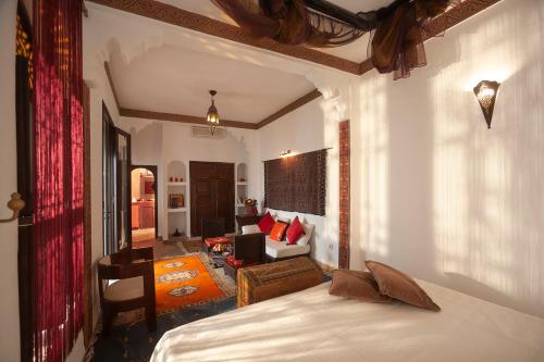 a bedroom with a bed and a living room at Riad Khabia & Spa in Marrakech