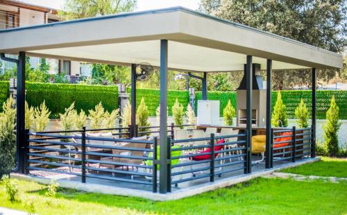 a gazebo in a park with benches at Orion Apart Tekirova in Kemer