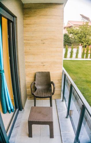 a chair on the balcony of a house at Orion Apart Tekirova in Kemer