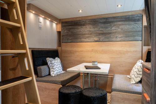 a small room with a table and a couch at Newby Bridge Country Caravan Park in Newby Bridge