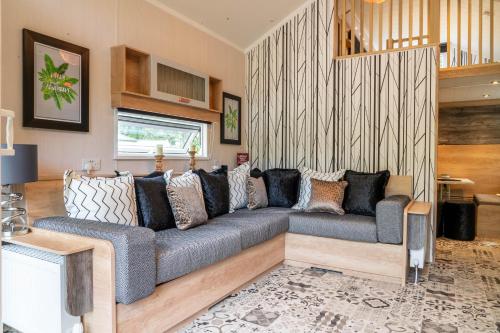 a living room with a gray couch in a room at Newby Bridge Country Caravan Park in Newby Bridge