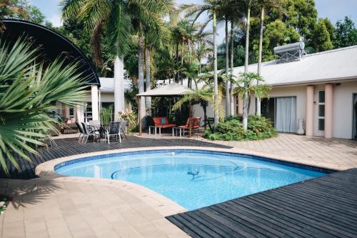 a swimming pool in front of a house at Rockview Lodge in Nelspruit