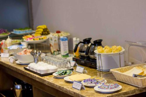 a buffet of food on a table with plates of food at REIWA INN APARTMENT in Hanoi