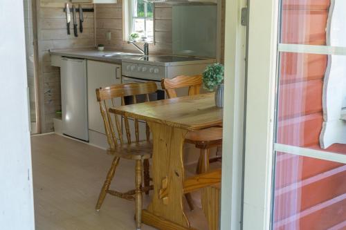 a kitchen with a wooden table and chairs at Danhostel Skanderborg in Skanderborg