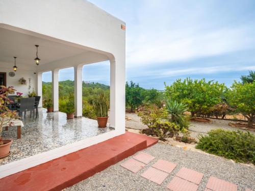 a view from the outside of a house with a patio at Holiday Home Can Fulgencio II by Interhome in Cala Llenya