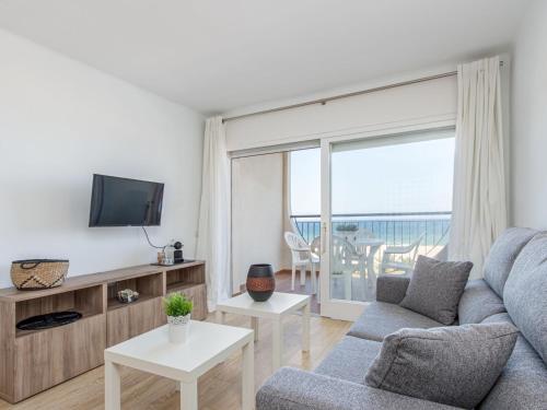 a living room with a couch and a tv at Apartment Bahia I by Interhome in Empuriabrava