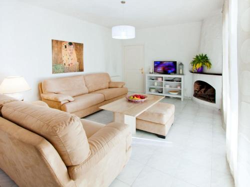 a living room with two couches and a fireplace at Holiday Home D'Ibis by Interhome in Empuriabrava