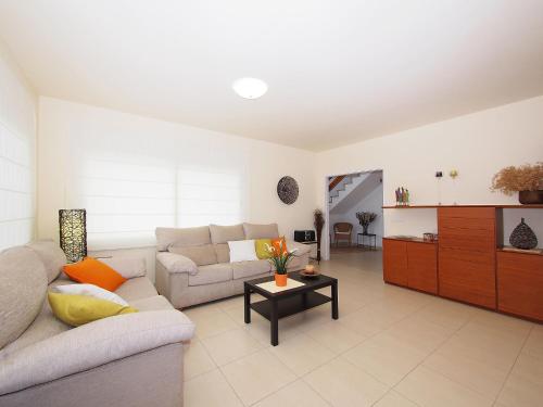 a living room with a couch and a table at Holiday Home Sant Mori by Interhome in Empuriabrava