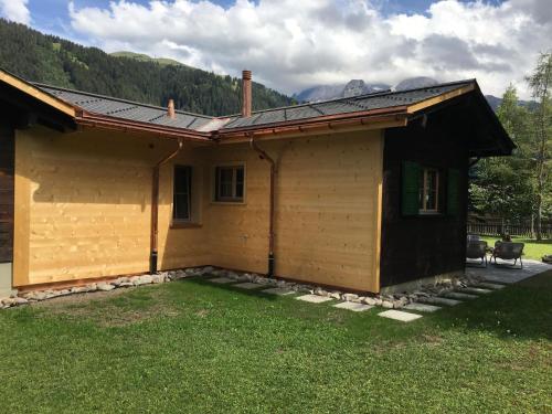 a house with a large yard in front of it at Apartment Andrea by Interhome in Lenk
