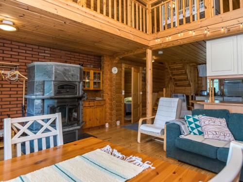 a living room with a couch and a stove at Holiday Home Niitsinniemi by Interhome in Laamala