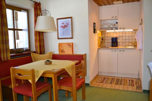 a kitchen and dining room with a table and chairs at Gästehaus Willfert in Reit im Winkl