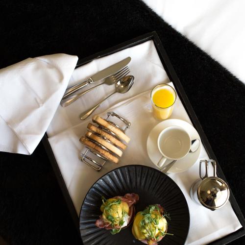 a tray with a plate of food and a cup of coffee at Milsoms Kesgrave Hall in Ipswich