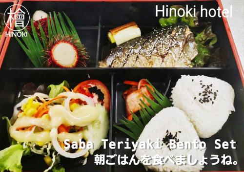 a plastic container filled with different types of food at Hinoki Hotel - ONSEN Chiang Mai in Chiang Mai