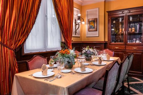 a dining room with a long table with chairs at Hotel Reina Cristina in Granada