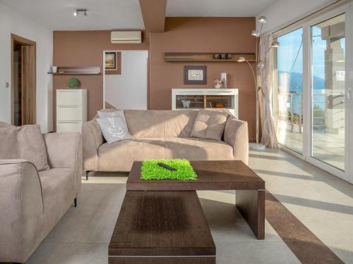a living room with a couch and a table at Holiday Home Senj by Interhome in Klarićevac