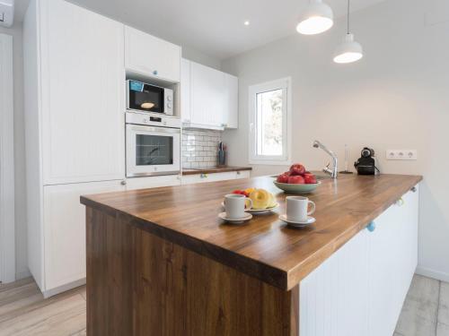 een keuken met een houten eiland met een fruitschaal erop bij Holiday Home Sangha by Interhome in Empuriabrava