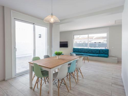 een eetkamer met een tafel, stoelen en een bank bij Holiday Home Sangha by Interhome in Empuriabrava