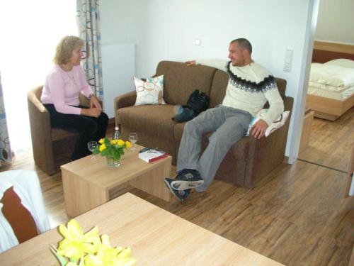a man and a woman sitting in a living room at Gasthof Blume in Hausach