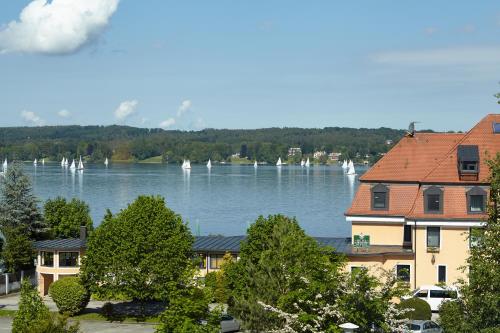 a view of a lake with boats in the water at Hotel Schloss Berg in Berg am Starnberger See