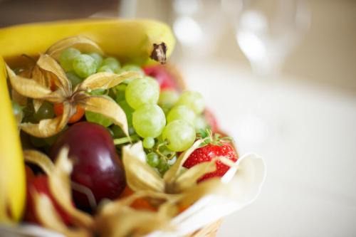 a glass bowl filled with fruit and vegetables at Hotel Schloss Berg in Berg am Starnberger See