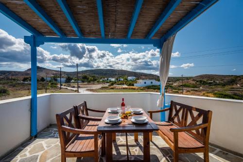 une table et des chaises sur un balcon avec vue dans l'établissement Heliovasilema Studios, à Pollonia