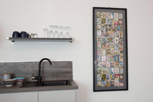a mirror hanging on a wall next to a kitchen sink at Blackbird Luxury Accommodation Room 10 in Blackpool