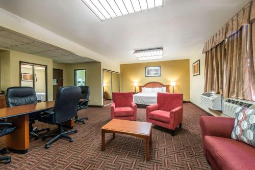 a hotel room with a bed and a desk and chairs at Quality Inn Colorado Springs South in Colorado Springs