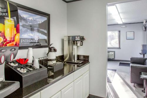 a kitchen with a counter with a coffee maker at Rodeway Inn in Groton