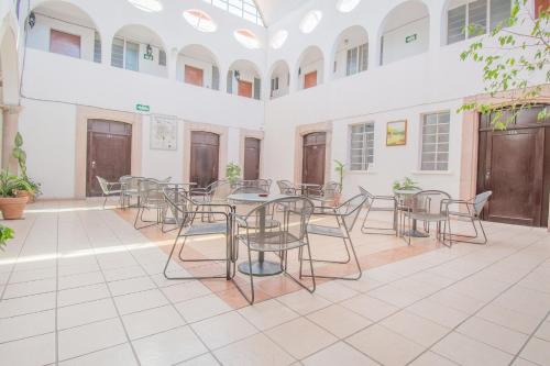 a room with tables and chairs in a building at Hotel Imperial in Aguascalientes