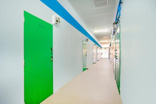 a corridor of a hospital with green and white walls at Baan Kim Lian SHA in Phuket Town
