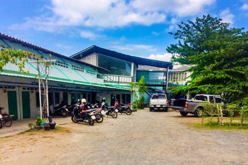 a group of motorcycles parked in front of a building at Baan Kim Lian SHA in Phuket Town