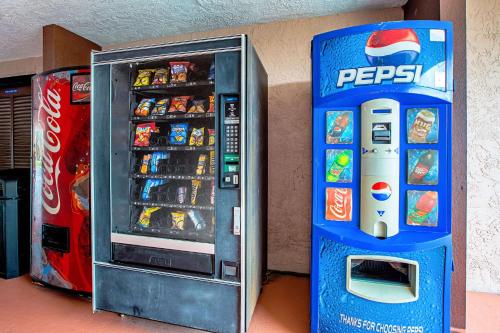 a pepsi soda machine next to a drink cooler at Quality Inn & Suites Live Oak I-10 Exit 283 in Live Oak