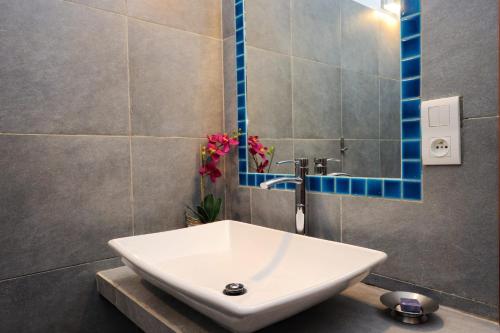 a bathroom with a sink and a mirror at Poisson Rouge in Bonifacio