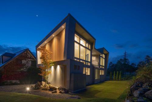 a large house with a lot of windows at Echo Rocks by The Hakuba Collection in Hakuba